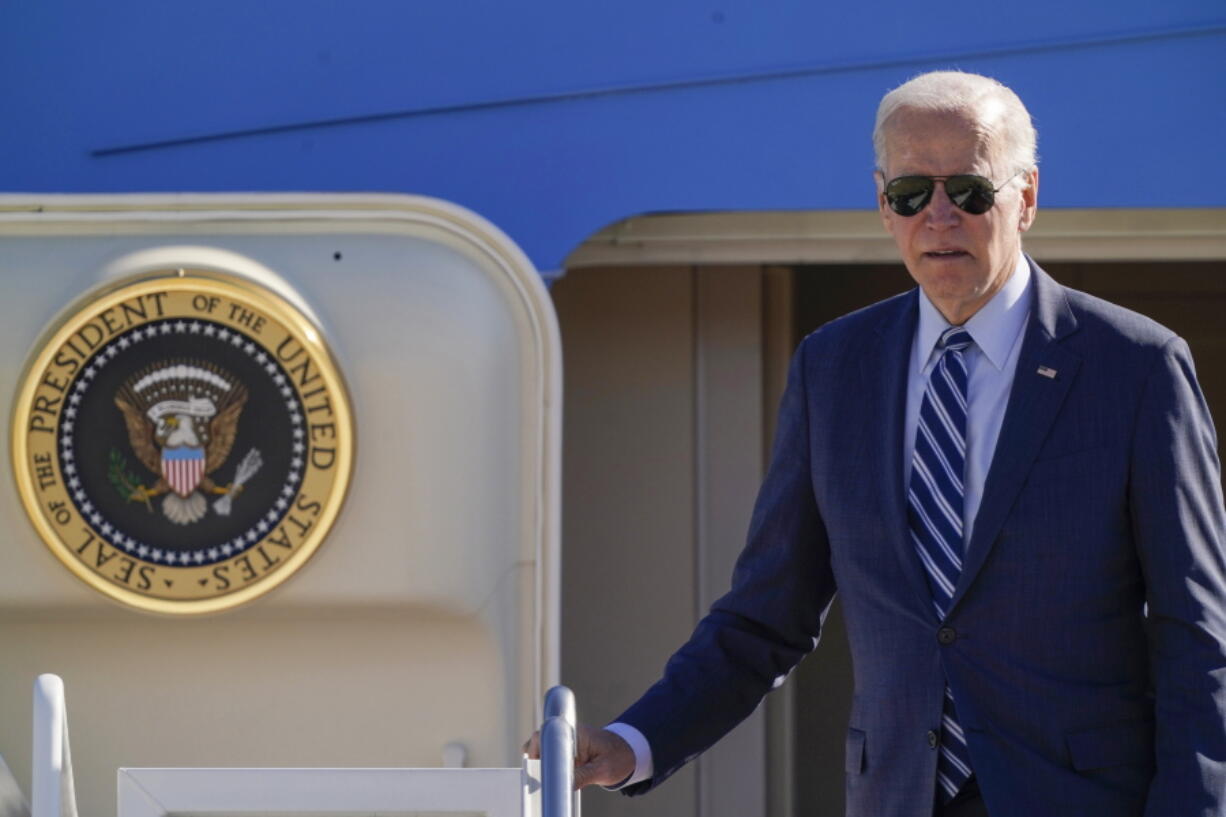 President Joe Biden pauses at the top of the stairs as he boards Air Force One at Andrews Air Force Base, Md., Thursday, Oct. 20, 2022, en route to Pennsylvania.