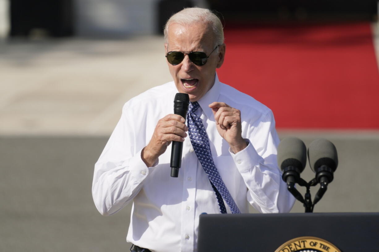 FILE - President Joe Biden speaks about the reducing inflation during a ceremony on the South Lawn of the White House in Washington, Sept. 13, 2022. Whenever the president travels, a special bullet-resistant lectern called the "blue goose," or its smaller cousin "the falcon," is in tow. Lately,  Biden is rendering them all but obsolete as he increasingly reaches for a hand-held microphone instead.  Those who know him best say the mic swap makes Biden a much more natural speaker.