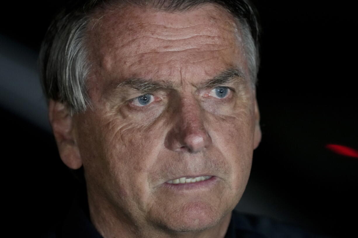 Brazilian President Jair Bolsonaro, who is running for another term, gestures during a press conference after general election polls closed in in Brasilia, Brazil, Sunday, Oct. 2, 2022.