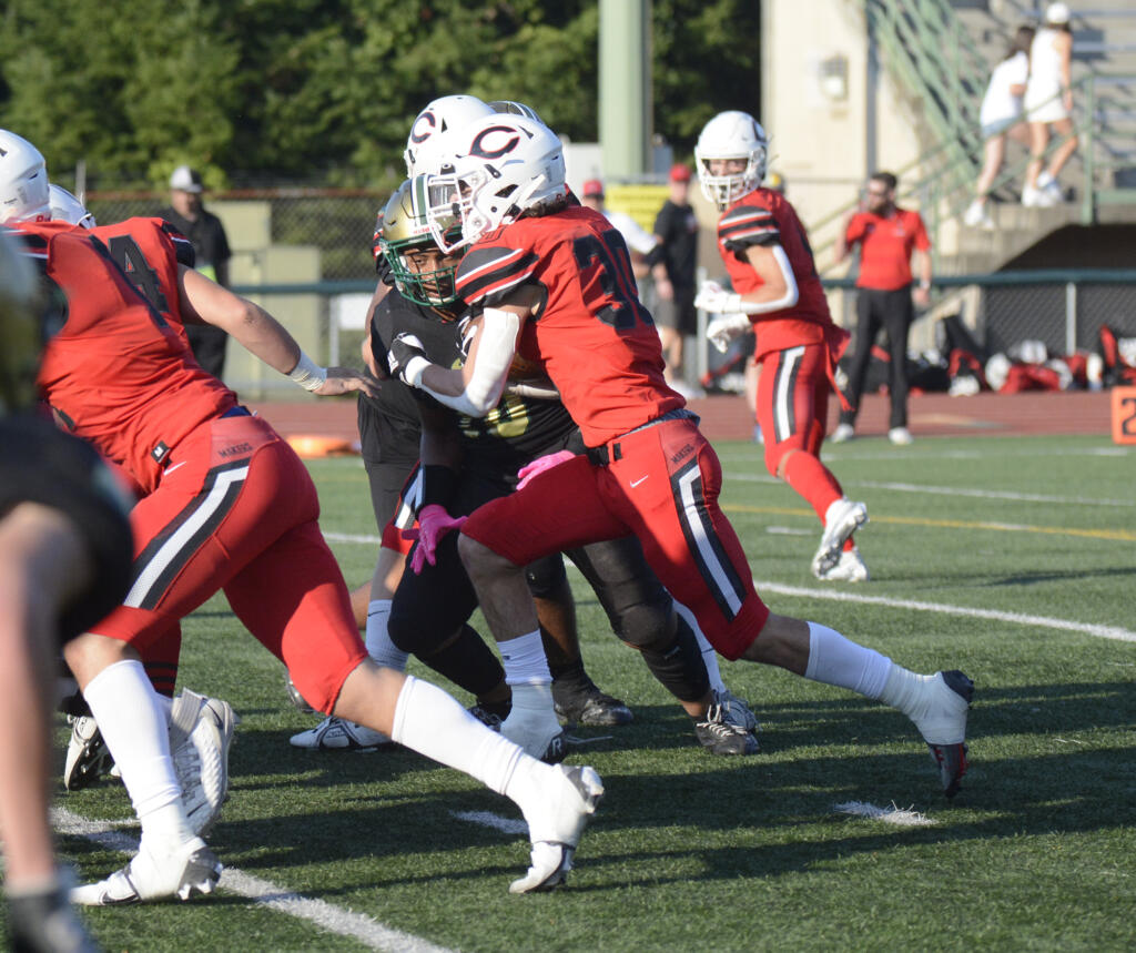 Camas running back Reid Tennant heads through the line for a gain during the Papermakers’ 42-14 win over Evergreen at McKenzie Stadium on Friday, Oct. 7, 2022.