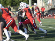 Camas running back Reid Tennant heads through the line for a gain during the Papermakers’ 42-14 win over Evergreen at McKenzie Stadium on Friday, Oct. 7, 2022.