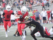 Camas running back Reid Tennant tries to elude a tackle during Camas’ 42-14 win over Evergreen at McKenzie Stadium on Friday, Oct. 7, 2022.