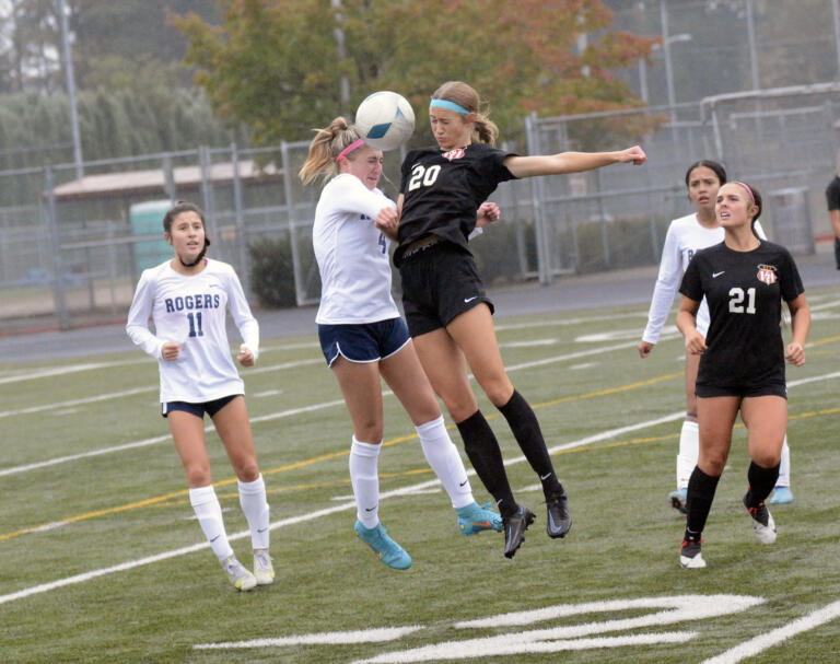 Camas' Parker Mairs (20) challenges Rogers' Aubrey Erath for a ball during Camas' 3-0 win over Rogers-Puyallup in a 4A bi-district soccer playoff match at Doc Harris Stadium on Saturday, Oct. 29, 2022.