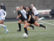 Camas senior Bella Burns strikes the ball during Camas' 3-0 win over Rogers-Puyallup in a 4A bi-district soccer playoff match at Doc Harris Stadium on Saturday, Oct. 29, 2022.