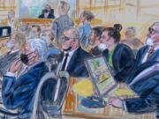 This artist sketch depicts the trial of Oath Keepers leader Stewart Rhodes and four others charged with seditious conspiracy in the Jan. 6, 2021, Capitol attack, in Washington, Thursday, Oct. 6, 2022. Shown above are, witness John Zimmerman, who was part of the Oath Keepers' North Carolina Chapter, seated in the witness stand, defendant Thomas Caldwell, of Berryville, Va., seated front row left, Oath Keepers leader Stewart Rhodes, seated second left with an eye patch, defendant Jessica Watkins, of Woodstock, Ohio, seated third from right, Kelly Meggs, of Dunnellon, Fla., seated second from right, and defendant Kenneth Harrelson, of Titusville, Fla., seated at right. Assistant U.S. Attorney Kathryn Rakoczy is shown in blue standing at right before U.S. District Judge Amit Mehta.