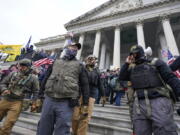 FILE - Members of the Oath Keepers on the East Front of the U.S. Capitol on Jan. 6, 2021, in Washington. A Florida man who stormed the U.S. Capitol with other members of the far-right Oath Keepers testified On Monday, Oct. 31, 2022, that he believed they were participating in a historic "Bastille-type event" reminiscent of the French Revolution.