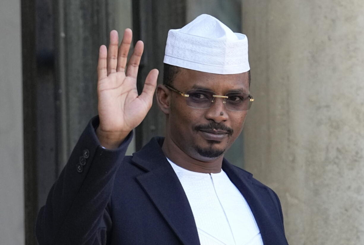 FILE - Chad's Gen. Mahamat Idriss Deby, the head of its military government, waves as he is welcomed by French President Emmanuel Macron for a meeting at the Elysee Palace in Paris, Nov. 12, 2021.