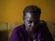 Karen Nix sits in her home before leaving for her evening work shift in New Orleans, Tuesday, Aug. 23, 2022. Nix tells her story of surviving hurricanes Katrina and Ida while living with cerebral palsy.