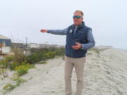 Mayor Patrick Rosenello stands atop a recently repaired dune in North Wildwood, N.J., on Tuesday, Oct. 25, 2022. The town used bulldozers to push sand back into piles to repair severe erosion from recent storms, despite a directive from state environmental officials not to do the work until the proper studies and planning took place.