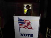 FILE - A person waits in line to vote in the Georgia's primary election on May 24, 2022, in Atlanta. A new poll shows 71% of voters think the future of the country is at stake when they vote in November's midterm elections. That's according to a new poll from The Associated Press-NORC Center for Public Affairs Research.