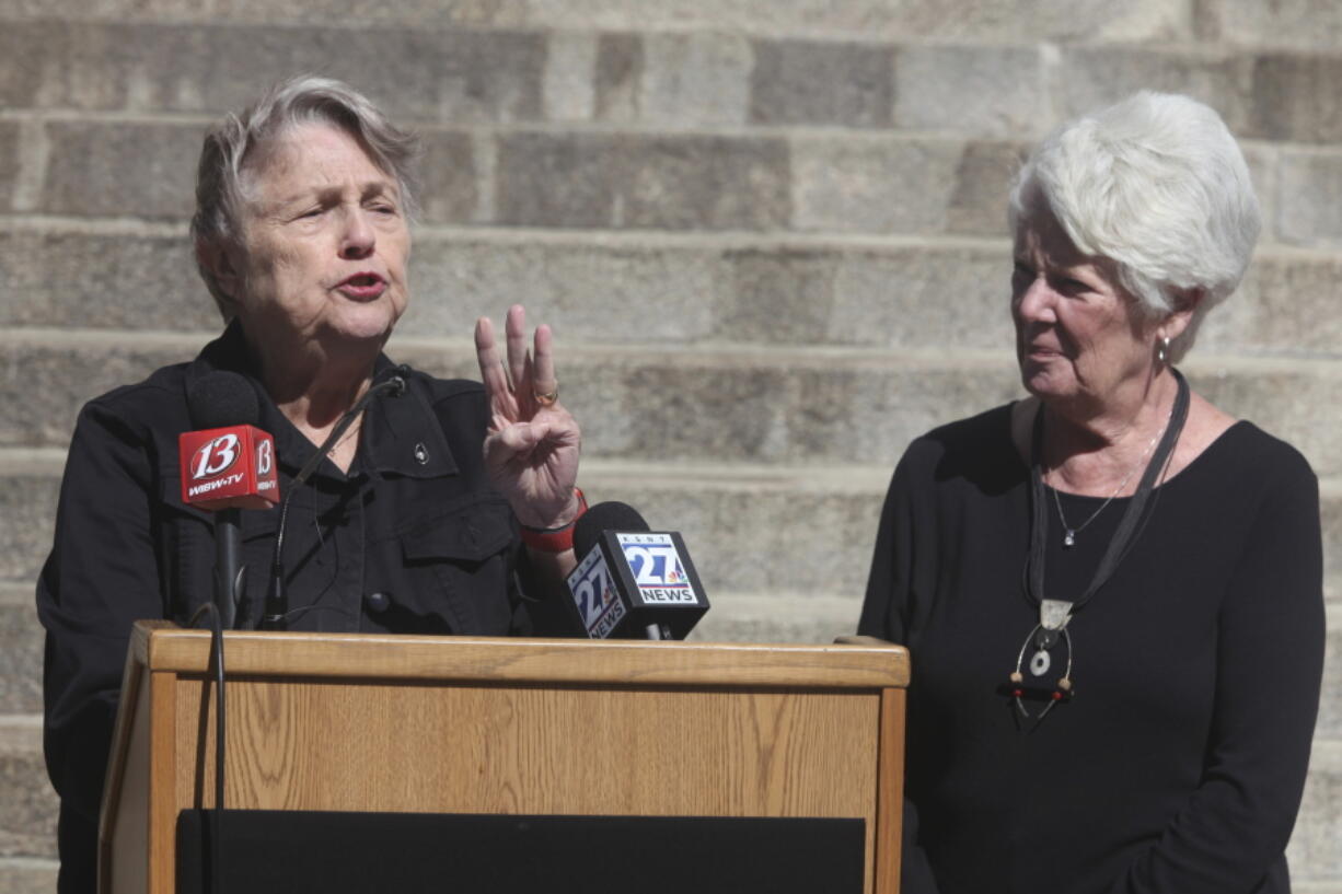 Former Kansas Democratic Party Chair and state Revenue Secretary Joan Wagnon, left, speaks during a rally for a new group, Keep Kansas Free, while former Insurance Commissioner Sandy Praeger, right, a Republican, watches on Thursday, Oct. 13, 2022, outside the statehouse in Topeka, Kan. The group formed to urge voters who support abortion rights to back like-minded candidates and retain Kansas Supreme Court justices on the bench as ways to protect abortion access.