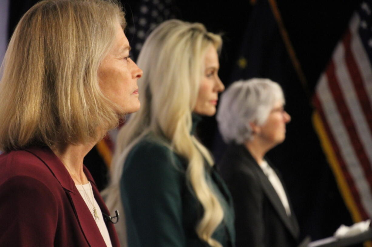 United States Sen. Lisa Murkowski, left, a Republican, looks on Thursday, Oct. 27, 2022, prior to a U.S. Senate debate in Anchorage, Alaska. She faces Republican Kelly Tshibaka, center, and Democrat Pat Chesbro, right, in the general election.