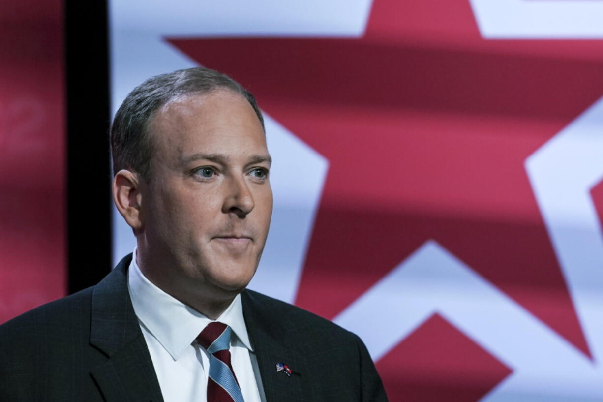 FILE - Suffolk County Congressman Lee Zeldin listens as he prepares to participate in New York's Republican gubernatorial debate at the studios of CBS2 TV, June 13, 2022, in New York. Zeldin, the Republican challenging New York Gov. Kathy Hochul in next month's election, has delivered his anti-crime message while speaking at buildings and bodegas in diverse New York City neighborhoods.