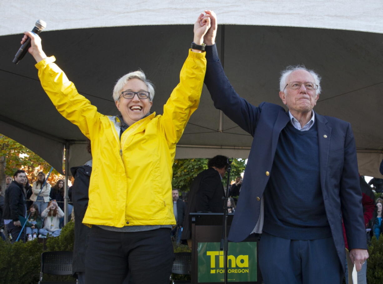 Oregon Democratic gubernatorial candidate Tina Kotek, left, and Vermont Sen. Bernie Sanders acknowledge the crowd during a visit to the University of Oregon campus in Eugene, Ore., Thursday, Oct. 27, 2022.  Sanders kicked off an eight-state tour Thursday, hoping to energize young voters and shore up support for vulnerable Democratic candidates ahead of the midterm elections.