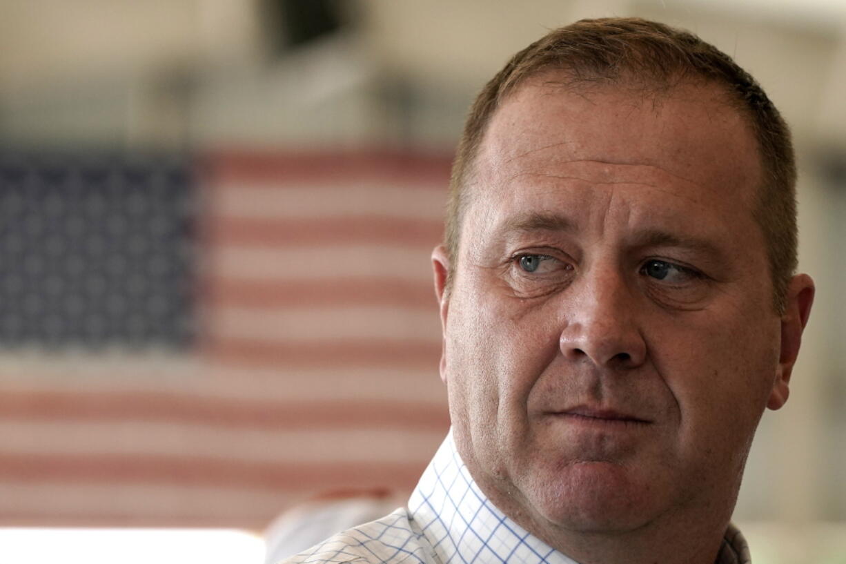 FILE - Republican U.S. Senate candidate and Missouri Attorney General Eric Schmitt listens to an attendee at the Governor's Ham Breakfast at the Missouri State Fair in Sedalia, Mo., on Aug. 18, 2022. Schmitt has filed 25 lawsuits in the past 20 months against President Joe Biden's administration, challenging policies on COVID-19 vaccinations, climate change, immigration and education, among other things.