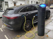 An electric vehicle charges at a public fast-charging station in London on Oct. 20, 2022. London and some other European cities are far ahead of the U.S. when it comes to making fast-charging accessible for renters who can't plug in their EVs at home in a private garage. In the United States, public charging for renters and others without private garages is a barrier to EV adoption.