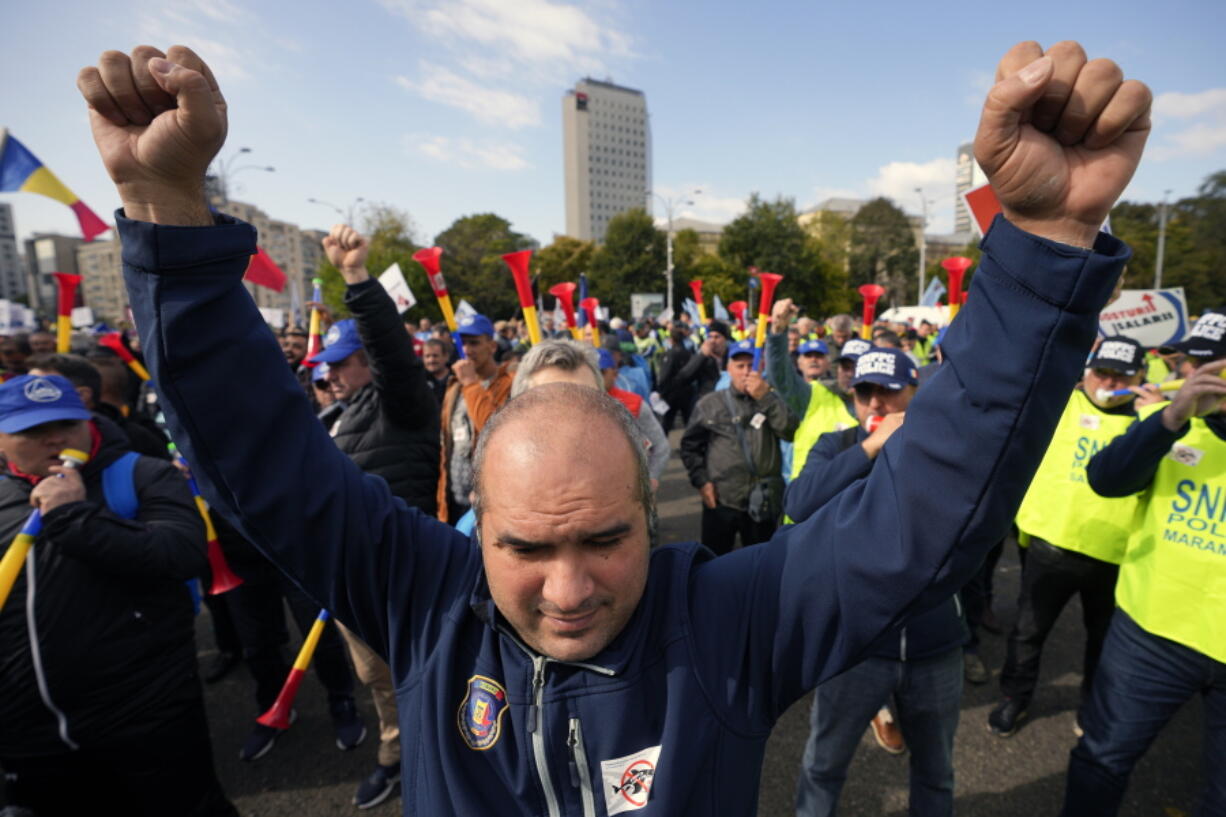 A man clenches his fists during a protest dubbed The Anti-Poverty March outside government headquarters in Bucharest, Romania, on Thursday.