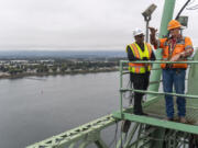 Interstate 5 Bridge Supervisor Marc Gross, right, and Interstate Bridge Replacement Program Administrator Greg Johnson talk Oct. 5 atop one of the Interstate 5 Bridge's lift towers. Johnson and his family were forced to move so a highway could be built on the homes' land. Johnson, who was in kindergarten, thought the moves were fun, but his siblings struggled with it. Two of his five siblings were held back a grade.