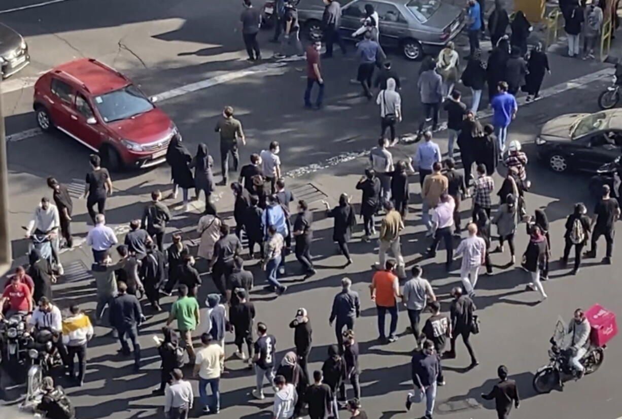 In this frame grab from video taken by an individual not employed by the Associated Press and obtained by the AP outside Iran shows people block an intersection during a protest to mark 40 days since the death in custody of 22-year-old Mahsa Amini, whose tragedy sparked Iran's biggest antigovernment movement in over a decade, in Tehran, Iran, Wednesday, Oct. 26, 2022.