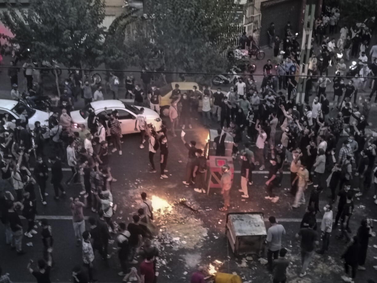 FILE - Iranians protest a 22-year-old woman Mahsa Amini's death after she was detained by the morality police, in Tehran, Sept. 20, 2022, in this photo taken by an individual not employed by the Associated Press and obtained by the AP outside Iran. Iran's atomic energy agency alleged Sunday, Oct. 23, 2022, that hackers acting on behalf of an unidentified foreign country broke into a subsidiary's network and had free access to its email system. Sunday's hack comes as Iran continues to face nationwide unrest first sparked by the Sept. 16 death of Amini.