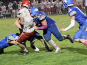 La Center’s Clayton Muffett (54) delivers a hit on Castle Rock’s Owen Langdon (8) during La Center’s 31-0 win over Castle Rock in La Center on Friday, Oct. 28, 2022.