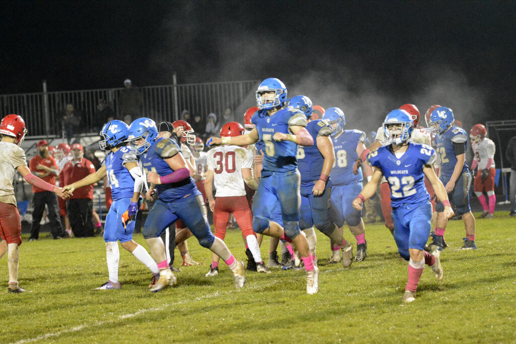 La Center’s Wyatt Eiesland (5) and Levi Giles (22) celebrate after La Center’s 31-0 win over Castle Rock in La Center on Friday, Oct. 28, 2022.