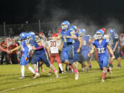 La Center’s Wyatt Eiesland (5) and Levi Giles (22) celebrate after La Center’s 31-0 win over Castle Rock in La Center on Friday, Oct. 28, 2022.