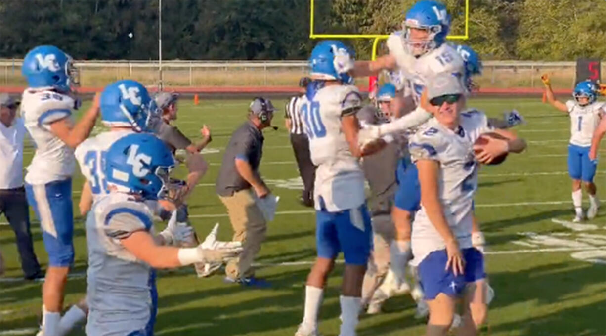 La Center players and coaches celebrate after their 26-25 comeback victory at Mount Baker on Saturday. The Wildcats were down 25-0 in the third quarter before rallying for the non-league win.