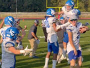 La Center players and coaches celebrate after their 26-25 comeback victory at Mount Baker on Saturday. The Wildcats were down 25-0 in the third quarter before rallying for the non-league win.