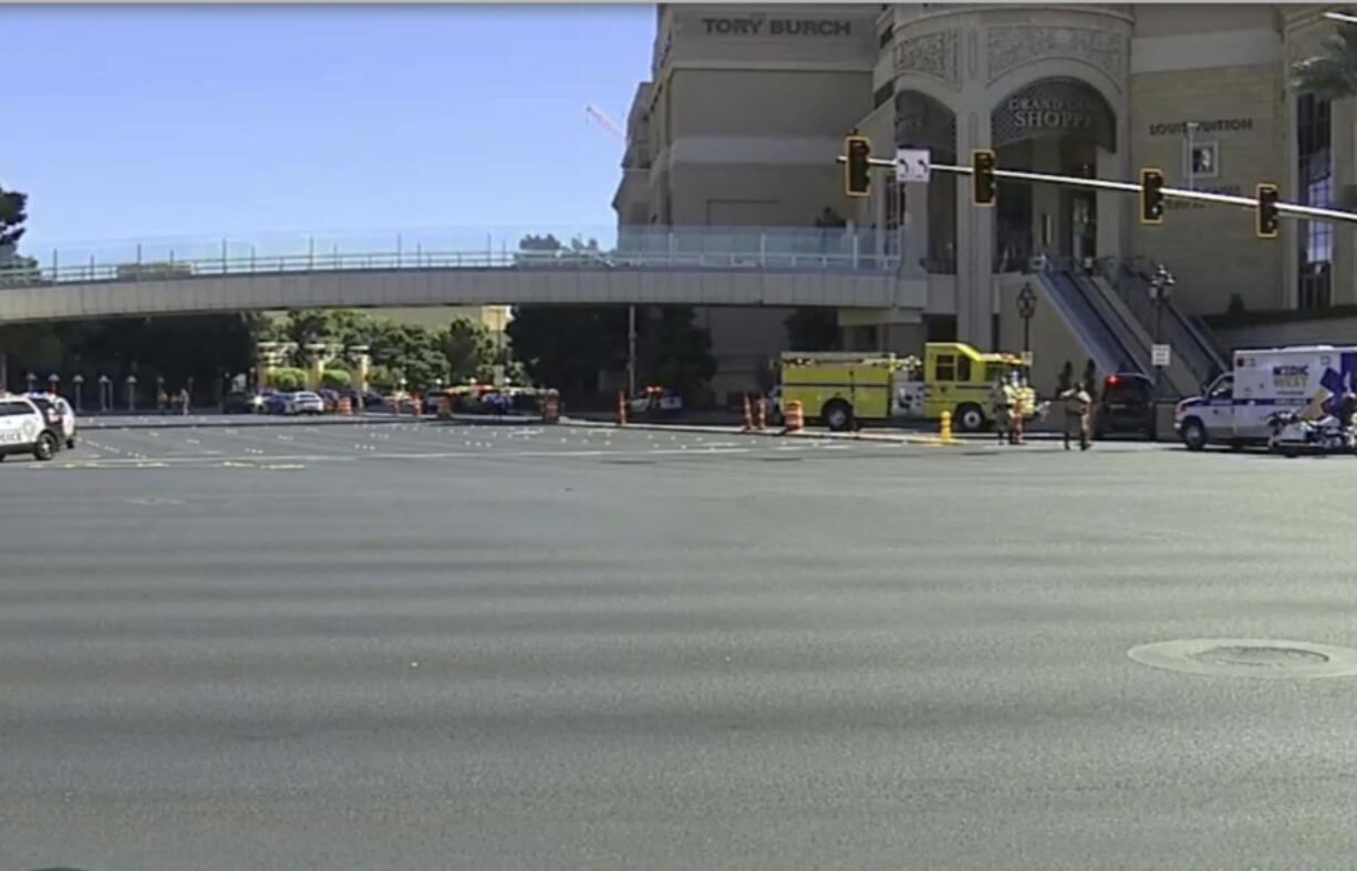 Emergency personnel respond the scene of a stabbing along the Las Vegas Strip on Thursday, Oct. 6, 2022.  Police say one person has been fatally stabbed and at least five others wounded.  A suspect is in custody.