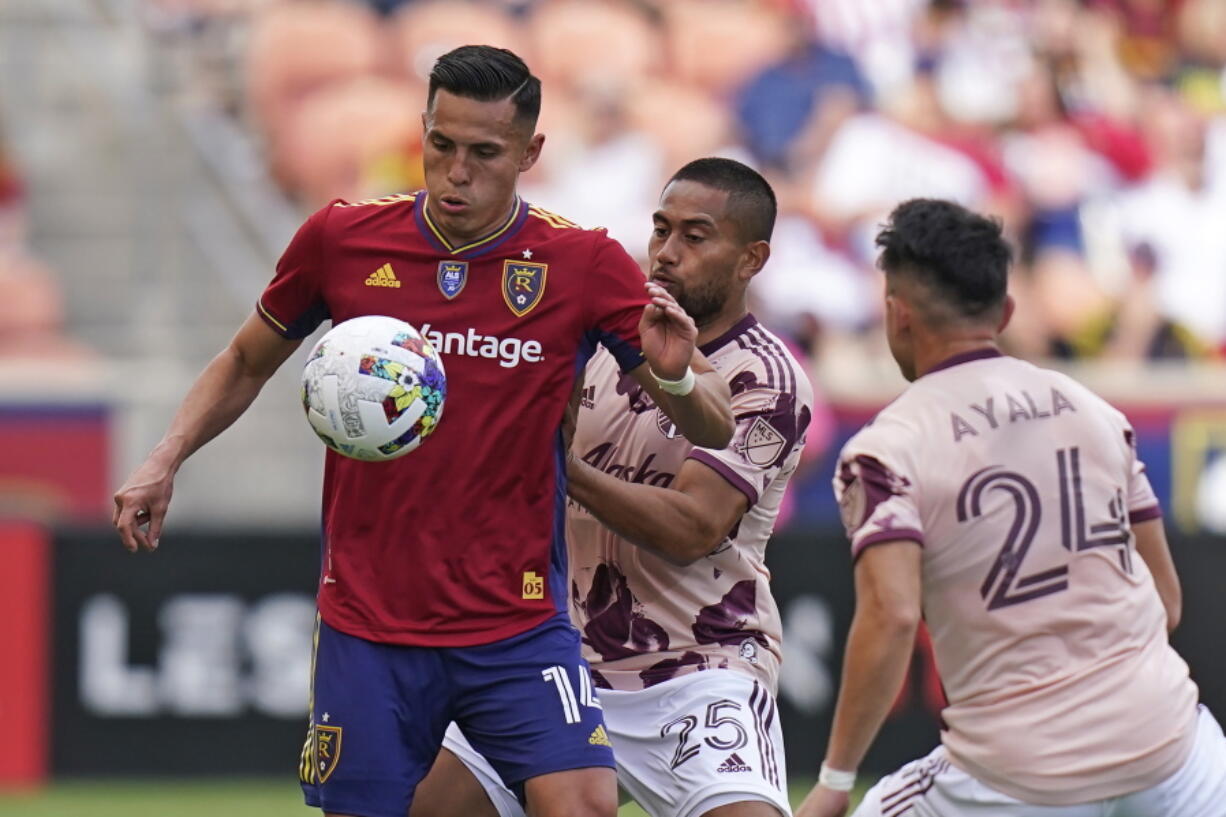 Portland Timbers defender Bill Tuiloma (25) defends against Real Salt Lake forward Rubio Rubin (14) during the first half of an MLS soccer match Sunday, Oct. 9, 2022, in Sandy, Utah.