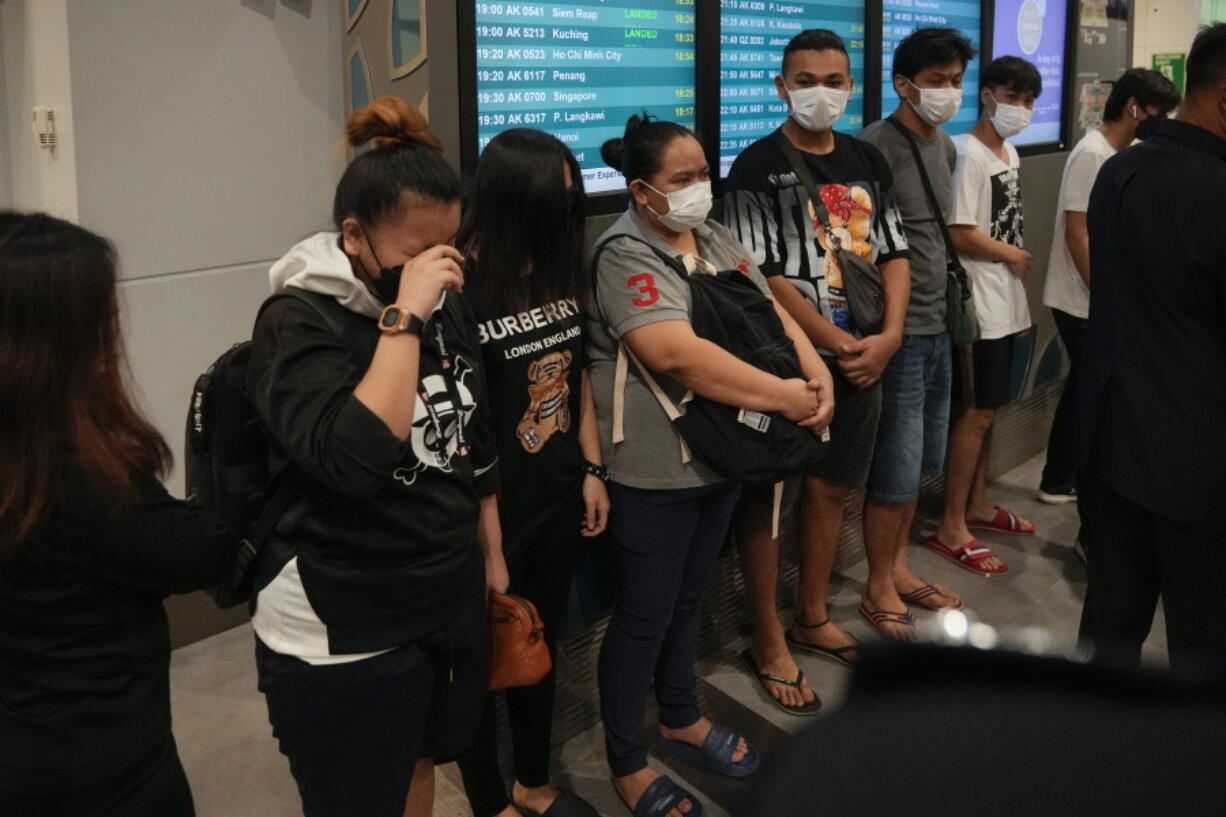 Malaysian youths rescued from human traffickers in Cambodia arrive at the Kuala Lumpur Airport Terminal in Sepang, Thursday, Oct. 6, 2022. Another 21 Malaysians rescued from human traffickers in Cambodia and Laos returned to the country Thursday, as the government intensified effort to detect scam victims stranded abroad.