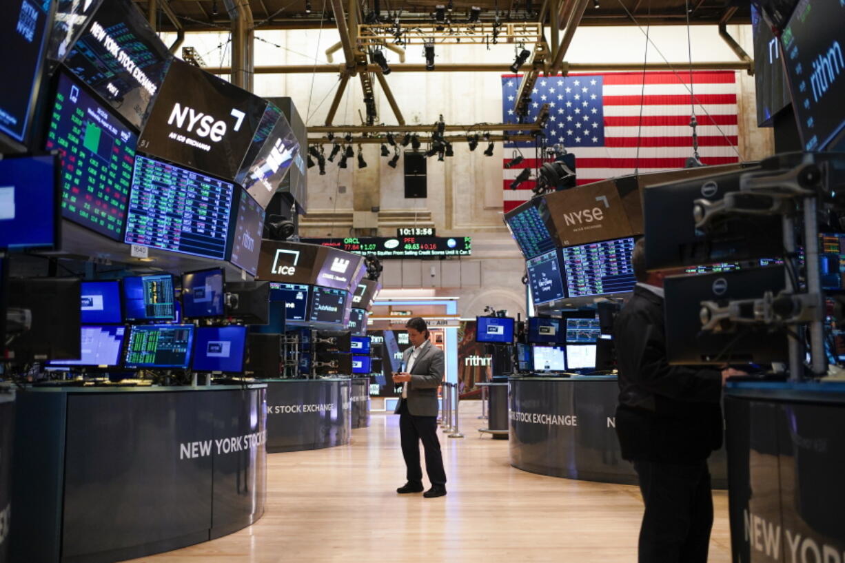 FILE - Traders work on the floor at the New York Stock Exchange in New York, Aug. 10, 2022. Stocks slipped in morning trading on Wall Street Wednesday, Oct. 26, 2022 and big technology stocks were the heavy weights on major indexes following several weak earnings reports and financial forecasts. The S&P 500 fell 0.4, despite more stocks gaining ground than falling in the benchmark index. The tech-heavy Nasdaq slipped 1.5%. The Dow Jones Industrial Average gained ground. Alphabet and Microsoft each slumped after reporting disappointing results.