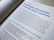 FILE - This Nov. 8, 2018 file photo shows a page from the 2019 U.S. Medicare Handbook in Washington.  Health insurers will flood the Medicare Advantage market again this fall with enticing offers of plans that have no monthly price tag. The number of so-called zero-premium plans has been growing for years, and they can appeal to retirees who live on fixed incomes.