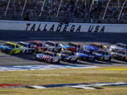 Ryan Blaney (12) leads the field through the tri-oval during a NASCAR Cup Series auto race Sunday, Oct. 2, 2022, in Talladega, Ala.