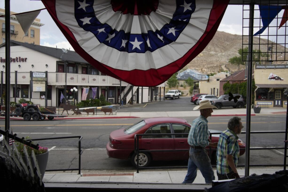 FILE - People walk along the main drag in the county seat of Nye County, Monday, July 18, 2022, in Tonopah, Nev. On Tuesday, Oct. 4, 2022, the ACLU's Nevada chapter filed a lawsuit against rural Nye County and its interim clerk to stop the implementation of the county's new hand-counting process, which was spurred by false claims of election fraud. The process entails hand-counting all paper ballots alongside a machine tabulator.