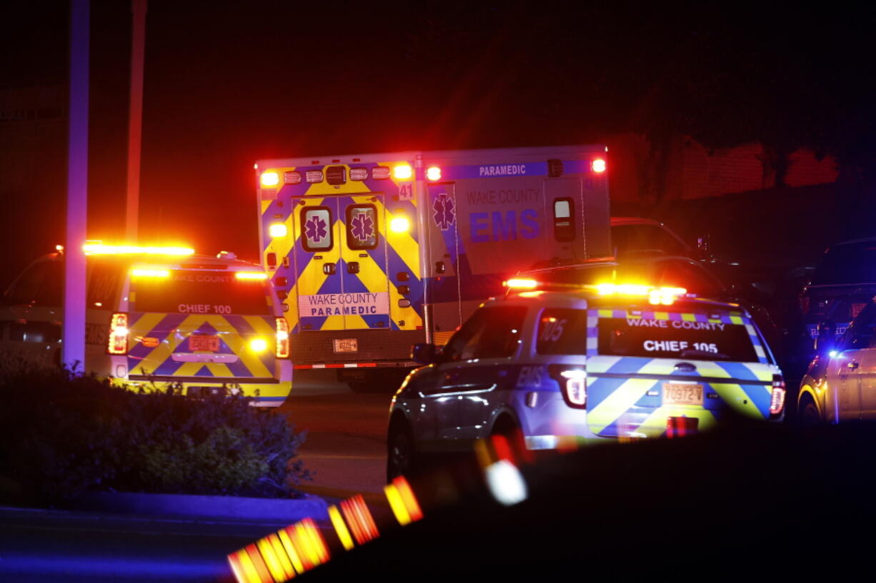 FILE - An ambulance believed to be carrying a shooting suspect arrives at Wake Medical Center Emergency Room in Raleigh, N.C., Thursday, Oct. 13, 2022, surrounded by police. North Carolina Democratic legislators pleaded with the General Assembly's Republican majority on Tuesday, Oct. 18 to consider gun safety and mental health measures, citing last week's shootings in Raleigh that left five people dead.