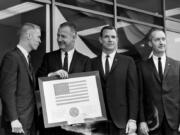 FILE - Vice President Spiro Agnew holds a framed American flag, presented to him by the crew of Apollo 9, as he poses with the astronauts March 26, 1969, in Washington. From left: Russell Schweikart, Agnew, and Air Force Cols. David Scott and James McDivitt. McDivitt, who commanded the Apollo 9 mission testing the first complete set of equipment to go to the moon, died Thursday, Oct. 13, 2022. He was 93.