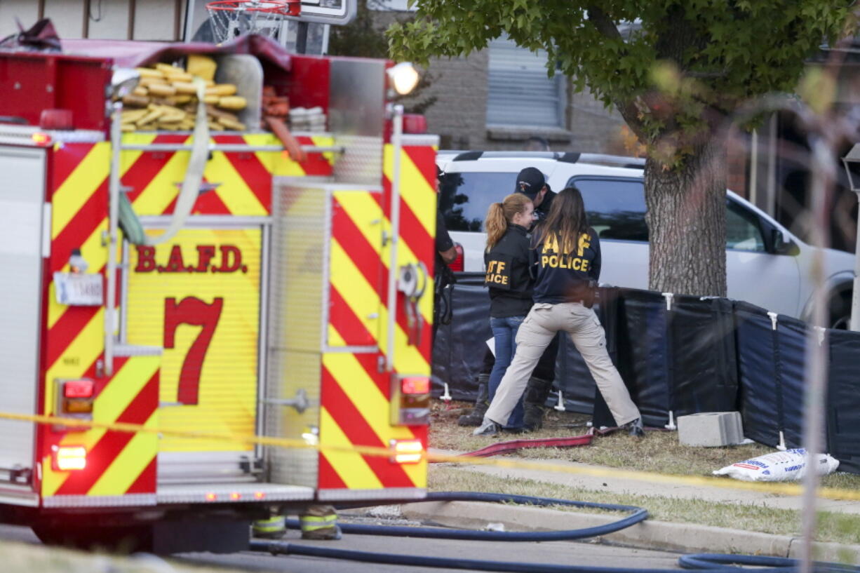 Broken Arrow, Okla., police and fire department investigate the scene of a fire with multiple fatalities at the corner South Hickory Ave. and West Galveston St. on Thursday, Oct. 27, 2022. Eight people were found dead Thursday after a fire was extinguished at a Tulsa-area house, and police said they were investigating the deaths as homicides.