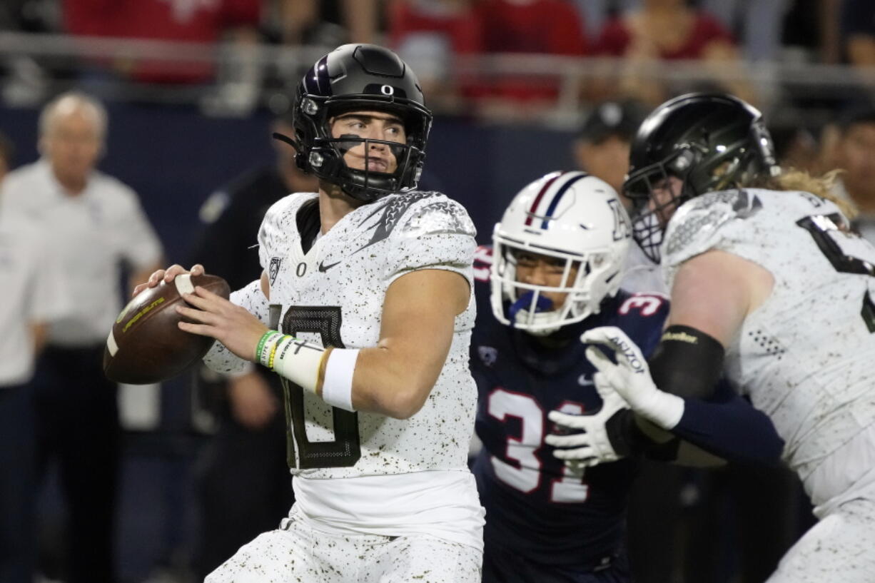 Oregon quarterback Bo Nix (10) looks for a receiver during the first half of the team's NCAA college football game against Arizona, Saturday, Oct. 8, 2022, in Tucson, Ariz.