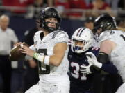 Oregon quarterback Bo Nix (10) looks for a receiver during the first half of the team's NCAA college football game against Arizona, Saturday, Oct. 8, 2022, in Tucson, Ariz.