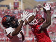 Utah cornerback Clark Phillips III, right, intercepts the ball from Oregon State wide receiver Tyjon Lindsey (1) during the second half of an NCAA college football game, Saturday, Oct. 1, 2022, in Salt Lake City.