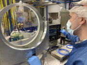 University of Michigan research scientist Andrew McKelvey inspects a prototype vacuum compatible mirror mount inside the ZEUS laser facility on Friday, Sept. 2, 2022, in Ann Arbor, Mich. The newly constructed facility will be home to the most powerful laser in the U.S.