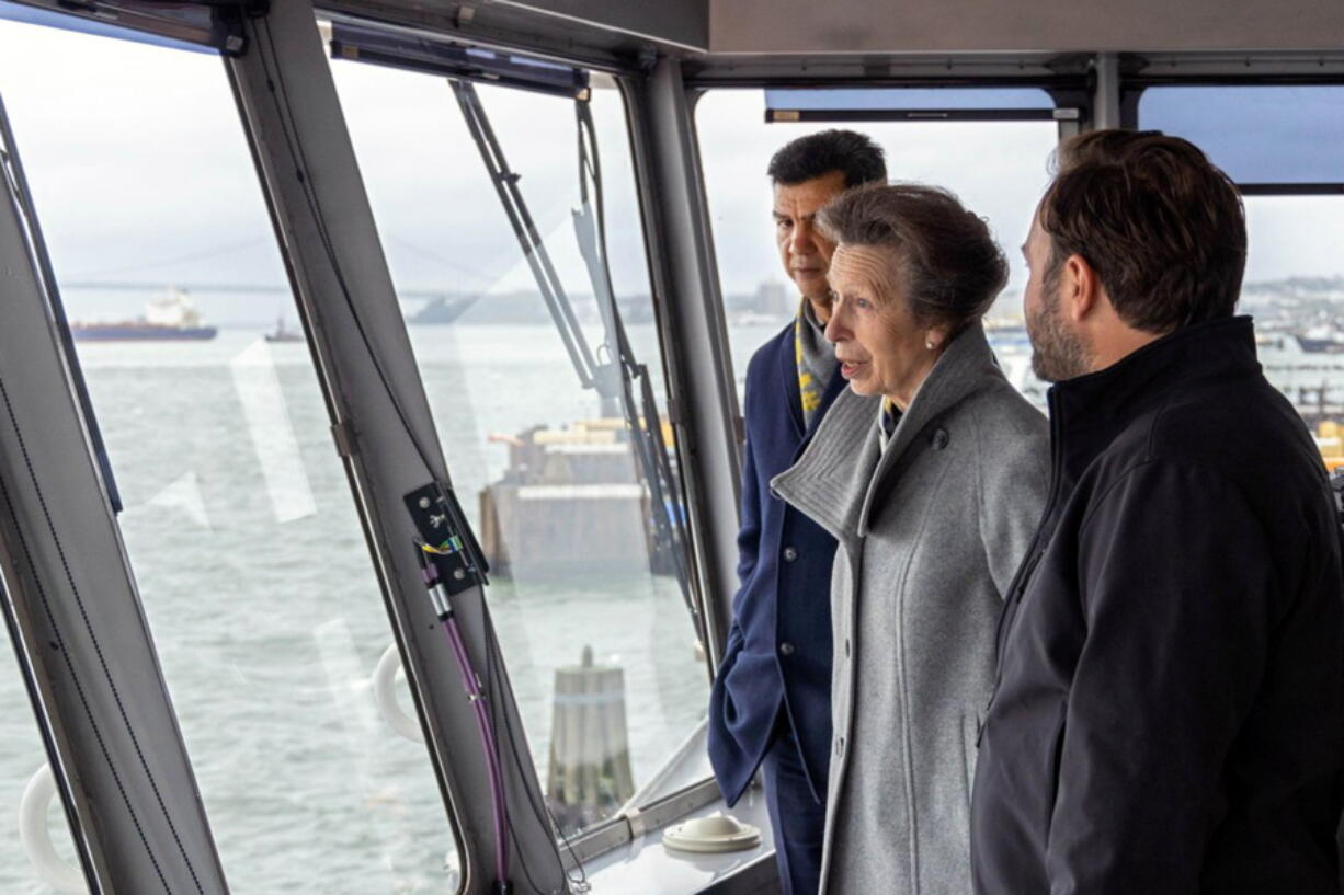 This photo, provided by the New York City Department of Transportation shows Britain's Princess Anne, accompanied by the agency's Commissioner Ydanis Rodriguez, left, as she rides in the pilothouse of the Staten Island Ferry "Sandy Ground," in New York Harbor, Tuesday, Oct. 4, 2022. The trip on a the commuter ferry came after the princess was given a tour of Staten Island's National Lighthouse Museum that included an an unveiling of a miniature figurine of Needles Lighthouse, in the Isle of Wight, in memory of her parents.