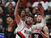 Houston Rockets forward Jabari Smith Jr., left, and Portland Trail Blazers center Jusuf Nurkic, right, battle for a rebound during the first quarter of an NBA basketball game in Portland, Ore., Friday, Oct. 28, 2022.