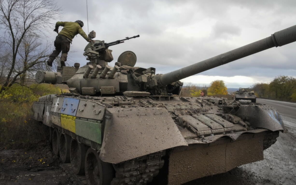 Ukrainian soldiers work with a captured Russian tank T-80 on the road to Bakhmut, the site of the heaviest battle against the Russian troops in the Donetsk region, Ukraine, Thursday, Oct. 27, 2022.