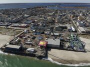 An amusement park sits next to the ocean in Seaside Heights, N.J., Thursday, Oct. 20, 2022. The Jet Star roller coaster, whose collapse into the ocean at Seaside Heights, N.J. during Sandy provided an iconic image of the storm's destruction, has been replaced with a new ride, built on the beach instead of over the water like its predecessor.