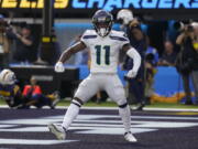 Seattle Seahawks wide receiver Marquise Goodwin (11) celebrates after scoring a touchdown during the first half of an NFL football game against the Los Angeles Chargers Sunday, Oct. 23, 2022, in Inglewood, Calif. (AP Photo/Mark J.