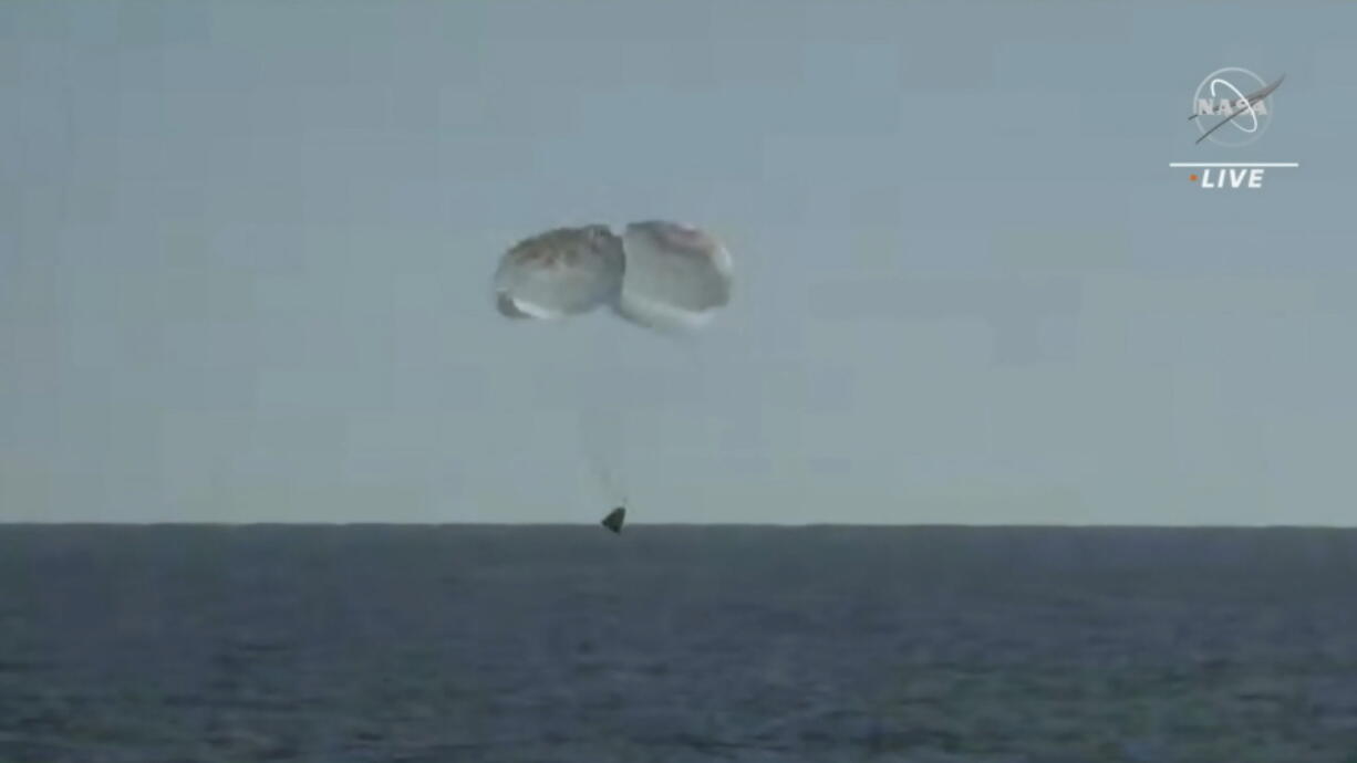 In this image from video made available by NASA, the SpaceX Crew Dragon Freedom capsule approaches surface of the Atlantic Ocean off Florida for splashdown on a return trip from the International Space Station on Friday, Oct. 14, 2022.