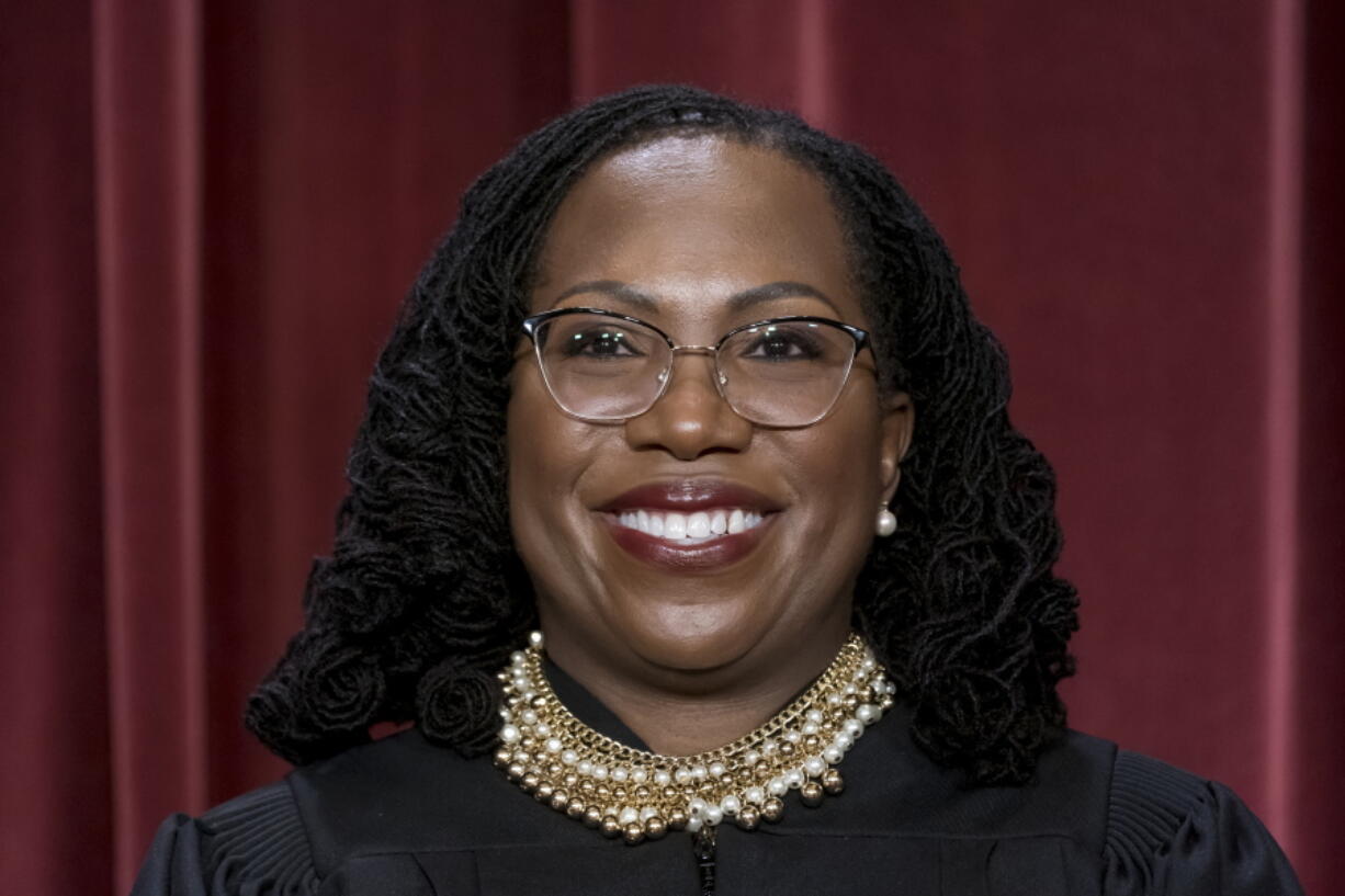 Associate Justice Ketanji Brown Jackson stands as she and members of the Supreme Court pose for a new group portrait following her addition, at the Supreme Court building in Washington, Friday, Oct. 7, 2022. (AP Photo/J.